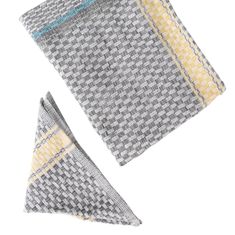 two gray and yellow napkins sitting next to each other