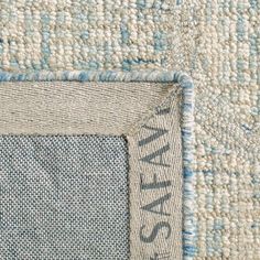 an area rug with blue and white designs on it, including the word's name