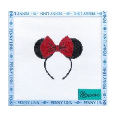 the cross stitch pattern is designed to look like minnie mouse ears with red bows on their heads