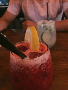 a person sitting at a table with a drink