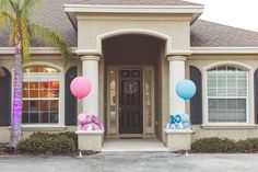 a house with balloons on the front and side of it, decorated for a baby's first birthday