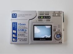 a silver camera sitting on top of a white table