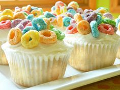 some cupcakes with cereal on them are sitting on a plate