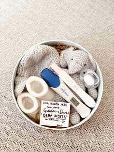 a small container filled with baby items on top of a table