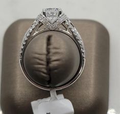 This Vintage Diamond Mounting Ring will be a show stopper! Ring is setup to hold a round cut Cubic Zirconium weighing approximately 1.00 ct. Mounting features 0.50ctw Round cut Diamonds, with G/H in color and SI1 in clarity. Ask a Sales Associate today to show you Featuring diamonds for this ring. All of our rings can be designed for different Shapes and Sizes featured stone. White Gold Princess Cut Diamond Ring With Vs Clarity, Princess Cut Diamond Ring Vs Clarity, Asscher Cut Diamond Wedding Ring With Vs Clarity, Halo Ring With Princess Cut Diamond, Diamond Ring With Halo Setting, Princess Cut, Diamond Rings With Halo Setting In Princess Cut, Diamond Rings With Princess Cut And Halo Setting, Halo Princess Cut Diamond Ring With Brilliant Cut, Diamond Halo Ring With Princess Cut