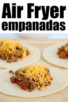 four homemade air fryer empanadas with cheese and ground beef on top