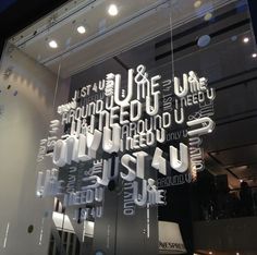 the front window of a store that has many different types of letters on display in it