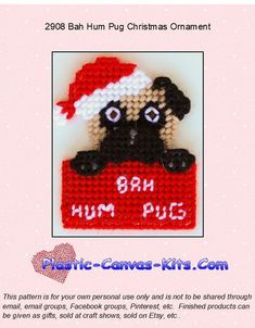 a cross stitch christmas ornament with a black pug in a santa's hat