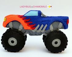 a toy monster truck with flames on it's tires