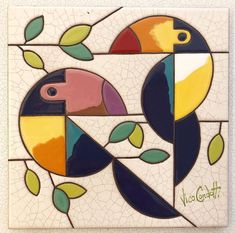 a colorful tile with birds and leaves on it