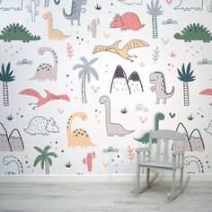 a child's room with dinosaur wallpaper and rocking chair in front of it