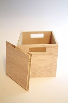 two wooden boxes sitting side by side on a white surface