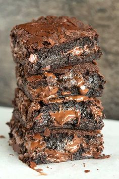 a stack of brownies with chocolate frosting on top