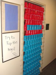 an office door is decorated with plastic cups