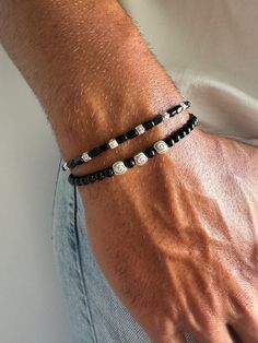 Elevate your style with our meticulously crafted pair of hematite beaded bracelets for men. Designed with a minimalistic aesthetic, the black and silver color combination exudes sophistication. The first bracelet features a central charm adorned with three tiny seashells, while the second boasts rectangular charms for a unique touch. Choose from four different dimensions for a perfect fit. Embrace this exclusive set, available only at Christina Christi Store. 👉 My Mens Bracelets Collection: htt Modern Beaded Bracelet With Black Beads As Gift, Minimal Bracelet, Black Beaded Bracelets, Shell Bracelet, Mens Beaded Bracelets, Hematite Beads, Bracelet Collection, Black Beads, Bracelets For Men