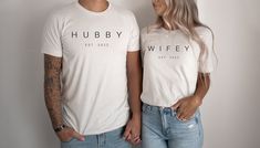 a man and woman standing next to each other wearing t - shirts that say hubby