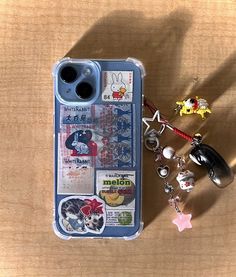 an iphone case with various items on it sitting next to a pair of ear buds