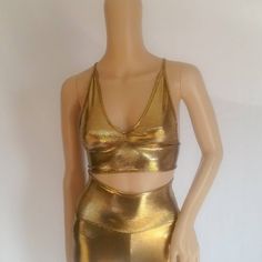 Gold Metallic Party Top Crosses And Laces Up In The Back. Made Of Spandex. Hand Wash Cold With Mild Soap. S- B Cup Top M-C Cup Top L-D Cup Top Xl Dd Cup Top Gold Fitted Disco Top, Fitted Metallic Crop Top For Summer, Chic Fitted Metallic Crop Top, Gold Stretch Tops For Party Season, Stretch Gold Tops For Party Season, Gold Fitted Crop Top For Party Season, Fitted Metallic Summer Tops, Fitted Metallic Tops For Summer, Gold Fitted Tops For Party Season