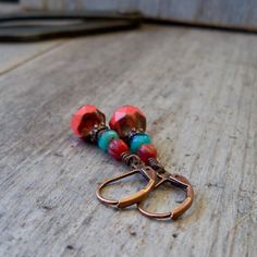 Perfect for your vacation to the tropics or if you can only dream about the islands. These earrings are sure to dress up your favorite summer dress or look great with those new jeans. Beautiful Czech glass bead in coral, orange, and turquoise. The largest bead is a 9mm. These are shown with copper, but are available with antique brass wire too. As always, these earrings are available with pure titanium ear wire. The titanium would be the same color as the antique brass. If you choose copper on t Adjustable Czech Glass Earrings With Ear Wire, Bohemian Jewelry With Czech Glass And Matching Earrings, Copper Dangling Beads Earrings For Gift, Copper Earrings With Dangling Beads For Gift, Nickel-free Red Earrings For The Beach, Handmade Copper Jewelry For Beach, Handmade Copper Jewelry For The Beach, Vintage Nickel-free Earrings For Beach, Vintage Beach Dangle Earrings