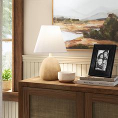 a table with a lamp and pictures on it