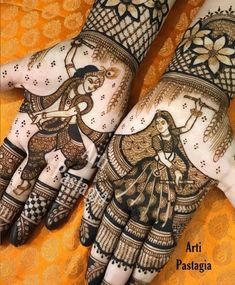 two hands with henna designs on them