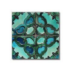 four square tiles with blue and green designs