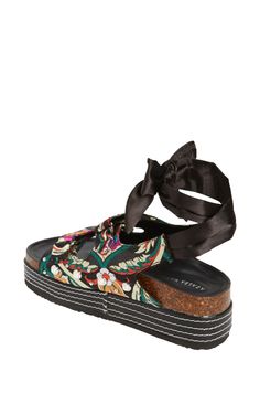 These black floral printed platform sandals feature a trendy slip on design with a black ribbon tie ankle closure. The black sole boasts white stitching for a touch of contrast. Perfect for adding a chic touch to any outfit. Platform Height: 1.5" Black Floral Print Sandals For Spring, Black Casual Platform Lace-up Sandals, Casual Black Platform Lace-up Sandals, Black Platform Lace-up Sandals For Beach, Black Platform Lace-up Summer Sandals, Black Platform Lace-up Sandals For Summer, Azalea Wang, Flatform Sandals, Floral Jacquard