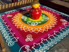 a brightly colored rug with a yellow bird on top and an orange vase in the middle