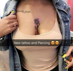 a woman with tattoos and piercings on her chest is holding onto a jean jacket