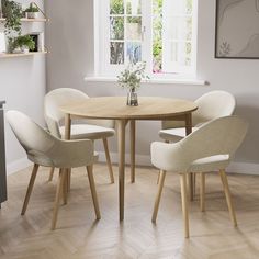 a dining table with four chairs around it