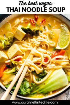 a bowl filled with noodles, broccoli and tofu