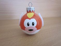 a red and white ornament with a monkey face on it