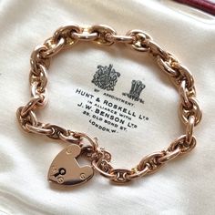 "This beautiful antique piece is a subtle twist on the classic curb \"charm\" bracelet, featuring anchor links instead, fastened by a traditional heart shaped padlock and secured with a safety chain, all mounted in 9ct rose gold. Circa 1900. Padlock stamped \"9CT\". Bracelet tested as 9ct. The bracelet measures approximately 190mm (L) x 7.2mm (W). The approximate weight is 13.5 grams. Please note that the antique box is for display purposes only. Thank you. CONDITION: In very good antique condition, with minimal surface wear commensurate with age. The padlock functions perfectly. LAYAWAY: We happily offer layaway/deposits on the majority of our items. Please send us a message if you would like to arrange a layaway. Layaways are not available on sale items. SHIPPING: All items are packed in Traditional Heart, Minimal Surface, Bracelet With Heart, Heart Padlocks, Antique Boxes, Safety Chain, Rose Gold Bracelet, Chain Link Bracelet, Link Bracelets