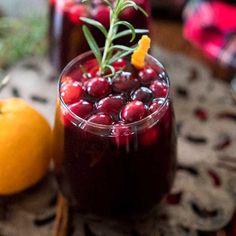 cranberry sauce in glasses with rosemary sprigs and oranges on the side