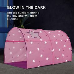 a pink tent with white stars on it and the words glow in the dark above it