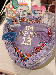 a birthday cake that has been decorated with pictures and magnets on the top it says i'm feeling 13