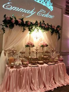 a table topped with lots of desserts under a sign