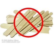 a pile of wooden sticks with a red circle in the middle