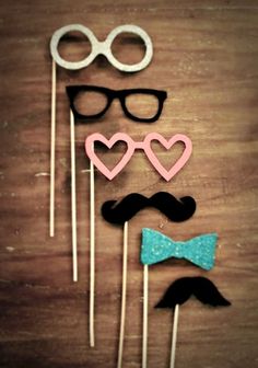 three mustaches, glasses and bow tie on sticks