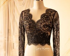 a mannequin with a black lace top on it's chest and sleeves