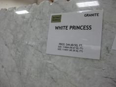 a white marble counter top with a sign on it that reads granite white princess price $ 60 99 / sq ft