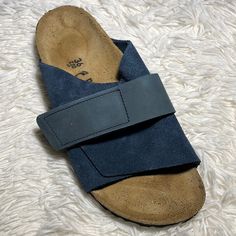 Birkenstock Kyoto Sandals Navy Suede 36n Wms 5-5.5 Nar-Med New In Box (Box May Be Damaged) Slide With Full Coverage Of The Foot And Two Velcro Closures For A Customized Fit. Straps Made With Premium Materials, Finely Crafted And Long-Lasting. Contoured Cork Footbed With Four Arches Ensures Even Weight Distribution And Proper Posture. Deep Heel Cup Keeps Your Heel’s Natural Cushioning Right Under The Heel Bone. Raised Toe Bar Encourages The Natural Gripping Motion Of Your Feet. Eva Sole. Suede Slip-on Slides For The Beach, Adjustable Slides With Ortholite Insole And Round Toe, Blue Leather Sandals With Arch Support, Casual Blue Slip-on Footbed Sandals, Comfortable Blue Leather Sandals, Blue Open Toe Sandals With Ortholite Insole, Blue Leather Footbed Slip-on Slides, Blue Leather Slides For Vacation, Blue Leather Slippers With Round Toe