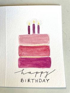 a birthday card with three candles sitting on top of a stack of books that says happy birthday