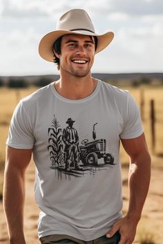 Vintage Farmer, Urban Harvest This t-shirt is a rebellious blend of old-world charm and urban edge. Featuring a bold, street art rendition of a classic 50s farmer, lost in the golden expanse of his cornfield, this design is a fresh take on nostalgia. The juxtaposition of traditional imagery with a contemporary, graffiti-inspired style creates a striking and thought-provoking piece. Wear it to celebrate the roots of our food, or simply as a bold fashion statement. The unisex soft-style t-shirt pu Graphic Tee Crew Neck T-shirt, Cotton T-shirt With Graphic Print For Gardening, Cotton Graphic Print T-shirt For Gardening, Zen Clothing, Farm Tees, Farm Tshirt, Farmer Shirt, Classic Garden, Outdoor Shirt