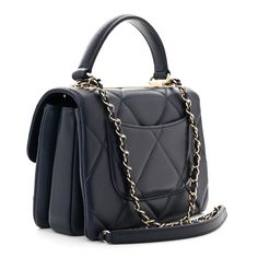 This is an authentic CHANEL Lambskin Quilted Small Trendy CC Top Handle Flap in Navy. This stylish handbag is crafted of diamond quilted lambskin leather in navy. This refined bag features a reinforced leather top handle, a gold chain leather threaded shoulder strap with a shoulder pad and gold hardware. These open to a partitioned navy leather interior with zipper and patch pockets. Cc Top, Leather Thread, Navy Leather, Diamond Quilt, Leather Chain, Leather Interior, Lambskin Leather, Leather Top, Shoulder Pads