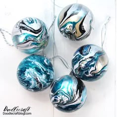 marbled glass ornaments are hanging on a string