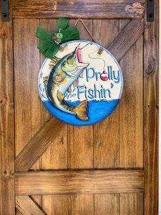 a fish door hanger on the side of a wooden door that says, pretty fishin '