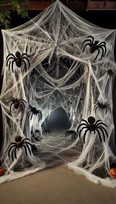 an outdoor halloween decoration with spider webs and pumpkins