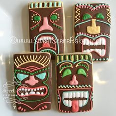 four decorated cookies with faces on them