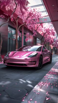 a pink car parked on the side of a road next to trees with pink flowers